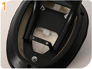 Locate the mounting bracket and screw points on the underside of the seat base.
